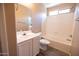 Bright bathroom features a modern vanity, wood-look flooring, and shower-over-tub at 310 E Payton St, San Tan Valley, AZ 85140