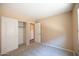 Neutral bedroom with window and closet with sliding doors and neutral carpet at 310 E Payton St, San Tan Valley, AZ 85140