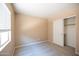 Neutral bedroom with window and closet with sliding doors and neutral carpet at 310 E Payton St, San Tan Valley, AZ 85140