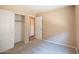 Neutral bedroom with window and closet with sliding doors and neutral carpet at 310 E Payton St, San Tan Valley, AZ 85140