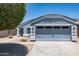 Charming single-story home featuring a well-maintained lawn and attached two-car garage at 310 E Payton St, San Tan Valley, AZ 85140