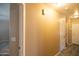 Beige hallway features a light colored floor and white doors at 310 E Payton St, San Tan Valley, AZ 85140