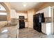 Modern kitchen featuring granite counters, sleek appliances, and ample white cabinet space at 310 E Payton St, San Tan Valley, AZ 85140