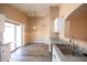 Bright eat-in kitchen features stainless steel sink, gray countertops and sliding doors to the outside at 310 E Payton St, San Tan Valley, AZ 85140