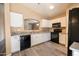 Modern kitchen featuring granite counters, sleek appliances, and ample cabinet space at 310 E Payton St, San Tan Valley, AZ 85140
