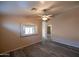 Spacious living room featuring sleek laminate floors, neutral walls, and a ceiling fan at 310 E Payton St, San Tan Valley, AZ 85140