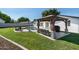 Backyard featuring a gazebo with outdoor seating, lush lawn, and pool at 3102 E Mariposa St, Phoenix, AZ 85016