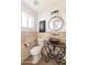 Powder room featuring stone walls, granite countertop, a copper bowl sink and dark bronze fixtures at 3102 E Mariposa St, Phoenix, AZ 85016