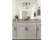 Bathroom featuring a gray vanity cabinet, granite countertop, decorative backsplash and dark hardware at 3102 E Mariposa St, Phoenix, AZ 85016