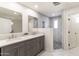 Spacious bathroom featuring double vanity, modern mirrors, marble floors, and stylish tiled shower at 3102 E Mariposa St, Phoenix, AZ 85016