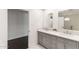 Bright bathroom featuring double vanity with gray cabinetry, modern mirrors, and views of a clean, organized space at 3102 E Mariposa St, Phoenix, AZ 85016