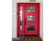 Stylish and modern front door with glass inserts and a vibrant red color at 3102 E Mariposa St, Phoenix, AZ 85016