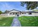Charming home with a well-manicured lawn, inviting walkway, and covered porch area at 3102 E Mariposa St, Phoenix, AZ 85016