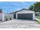 A modern two car garage with black trim accents surrounded by an ample concrete driveway and beautiful yard at 3102 E Mariposa St, Phoenix, AZ 85016