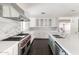 Gourmet kitchen with marble backsplash, professional range, and large center island at 3102 E Mariposa St, Phoenix, AZ 85016