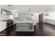 Open kitchen features large center island, stainless appliances, and modern cabinetry at 3102 E Mariposa St, Phoenix, AZ 85016