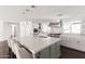 Bright kitchen features an oversized island with marble countertops and stainless steel appliances at 3102 E Mariposa St, Phoenix, AZ 85016