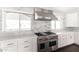 Gourmet kitchen features stainless steel range, hood, and custom cabinets at 3102 E Mariposa St, Phoenix, AZ 85016