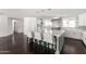 Kitchen island featuring seating, stainless steel appliances, and modern pendant lighting at 3102 E Mariposa St, Phoenix, AZ 85016