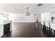 Expansive living room with hardwood floors, a modern light fixture, and backyard views at 3102 E Mariposa St, Phoenix, AZ 85016