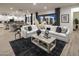Open-concept living room featuring a plush sectional sofa and seamless transition to the outdoor patio at 3332 W Sunstone Dr, San Tan Valley, AZ 85144