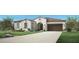 Stunning single-story home featuring stucco siding, red tile roof, two-car garage, and arched entryway at 3390 W Sunstone Dr, San Tan Valley, AZ 85144