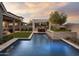 Backyard view of a refreshing pool with a pergola-covered dining area and mountain views at 3419 W Sunstone Dr, San Tan Valley, AZ 85144