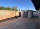 A large storage shed sits at the end of a concrete patio area in the backyard at 344 E Aepli Dr, Tempe, AZ 85282