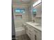 A renovated bathroom featuring a double vanity, and a tiled shower-over-tub at 344 E Aepli Dr, Tempe, AZ 85282