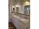 Traditional bathroom featuring a double vanity with granite countertop and matching framed mirrors at 344 E Aepli Dr, Tempe, AZ 85282