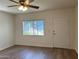 Bedroom featuring wood-look floors, natural light, a ceiling fan, and convenient access to the outside at 344 E Aepli Dr, Tempe, AZ 85282