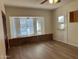 Spacious bedroom with wood-look floors, a brick window bench, and natural light from the white-framed windows at 344 E Aepli Dr, Tempe, AZ 85282
