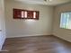 Well-lit bedroom with wood-look floors and dark wood shutters, offering a cozy and inviting space at 344 E Aepli Dr, Tempe, AZ 85282