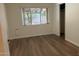 Bedroom with wood-look floors and a bright window at 344 E Aepli Dr, Tempe, AZ 85282