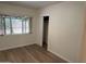 Bedroom with laminate flooring, closet and window offering view to outdoors at 344 E Aepli Dr, Tempe, AZ 85282