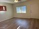 Bright bedroom featuring wood-look floors, a ceiling fan, natural light, and a door to the outside at 344 E Aepli Dr, Tempe, AZ 85282
