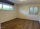 This is a well-lit bedroom with wood-look floors and a large window at 344 E Aepli Dr, Tempe, AZ 85282