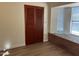Bedroom featuring wood-look flooring and shutters alongside a brick window bench area at 344 E Aepli Dr, Tempe, AZ 85282