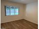 Bedroom featuring laminate flooring and window offering view to outdoors at 344 E Aepli Dr, Tempe, AZ 85282