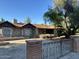 Front view of the house with its unique stone exterior and mature trees in the yard at 344 E Aepli Dr, Tempe, AZ 85282