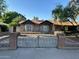 Charming stone facade home with a brick and wrought iron fence under a clear blue sky at 344 E Aepli Dr, Tempe, AZ 85282