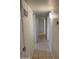 Hallway with tile flooring and white walls connecting several rooms at 344 E Aepli Dr, Tempe, AZ 85282