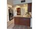 Kitchen with stainless steel refrigerator and eat-in bar at 344 E Aepli Dr, Tempe, AZ 85282