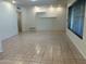 Bright, open living space with floating shelves, tile floors and large windows at 344 E Aepli Dr, Tempe, AZ 85282