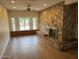 Spacious living room with a stone fireplace, large windows, and modern flooring at 344 E Aepli Dr, Tempe, AZ 85282