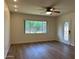 Bright living room with wood-look floors, ceiling fan, and a view to the outdoors at 344 E Aepli Dr, Tempe, AZ 85282