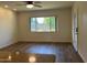 This inviting space has wood floors, neutral walls, a window, and a ceiling fan at 344 E Aepli Dr, Tempe, AZ 85282