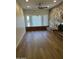 Bright and spacious living room with stone fireplace, large window and wood-look flooring at 344 E Aepli Dr, Tempe, AZ 85282