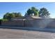 Street view of a single-story home featuring a secure wooden gate and a privacy block wall at 344 E Aepli Dr, Tempe, AZ 85282
