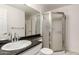 Bathroom featuring a glass shower, tile floors, large mirror, granite countertops, and a white vanity at 3633 N 3Rd Ave # 2031, Phoenix, AZ 85013